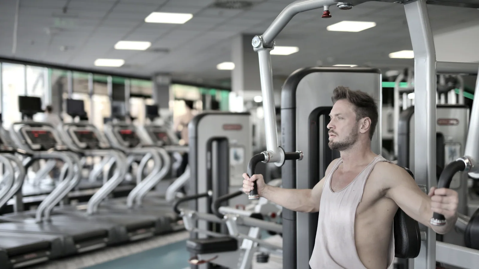 Sporter traint met een chest-press-machine in een fitnesscentrum